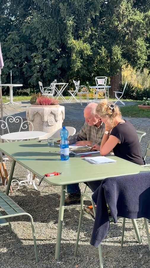 Heleen and Ignazio going over the vineyard work at the garden table
