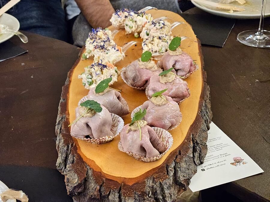 Rocco's aperitivo board: vitello tonnato and insalata russa, with the evening's menu card