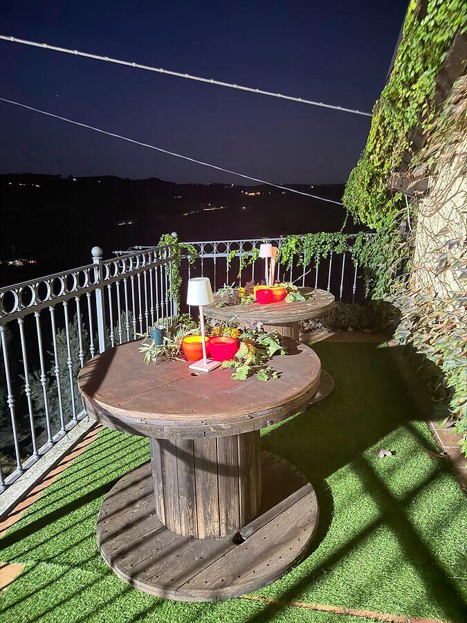 The terrace at Cantina Sant'Evasio at dusk, set for the group